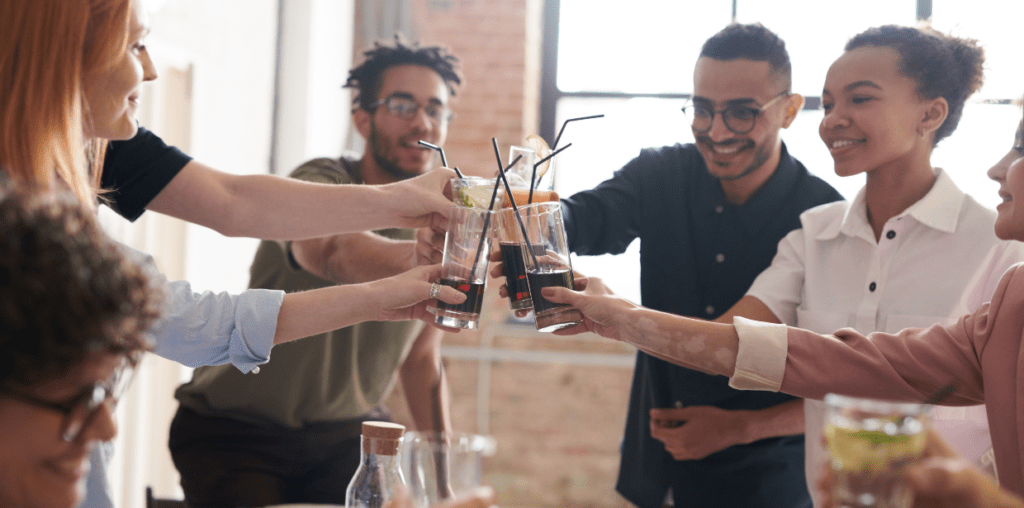 Friends drinking soda at an event